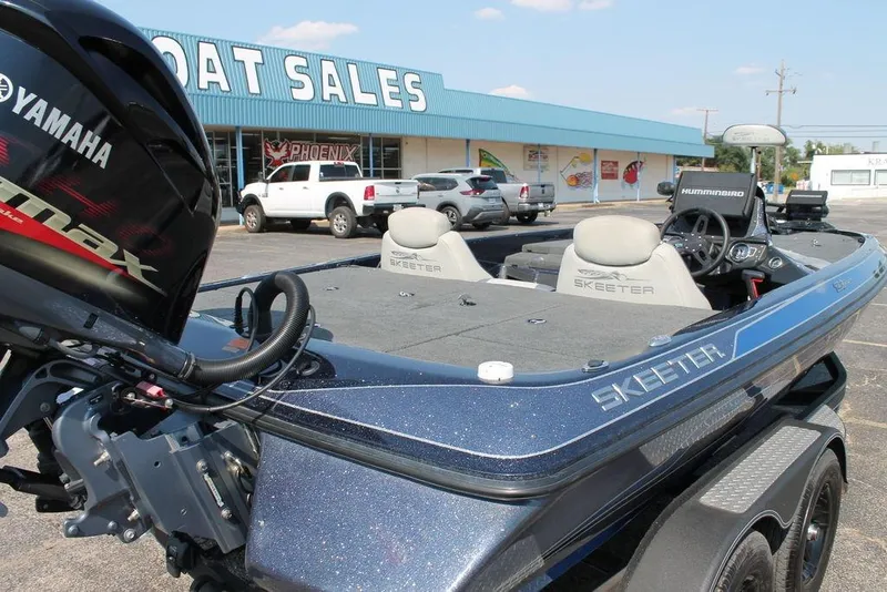 Slide: The Image of 2021 Skeeter ZX225 boat with Yamaha engine at dealership parking lot. - 5