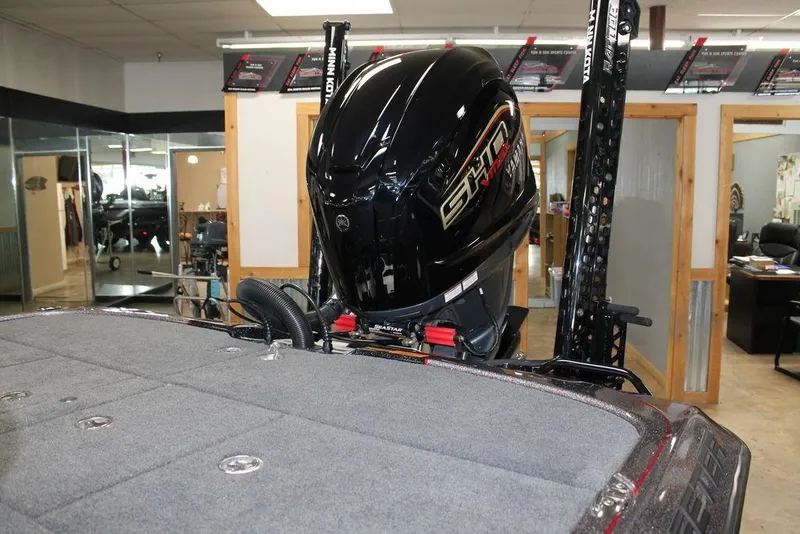 Slide: The Image of 2025 Skeeter FXR21L boat with powerful engine in showroom setting. - 5