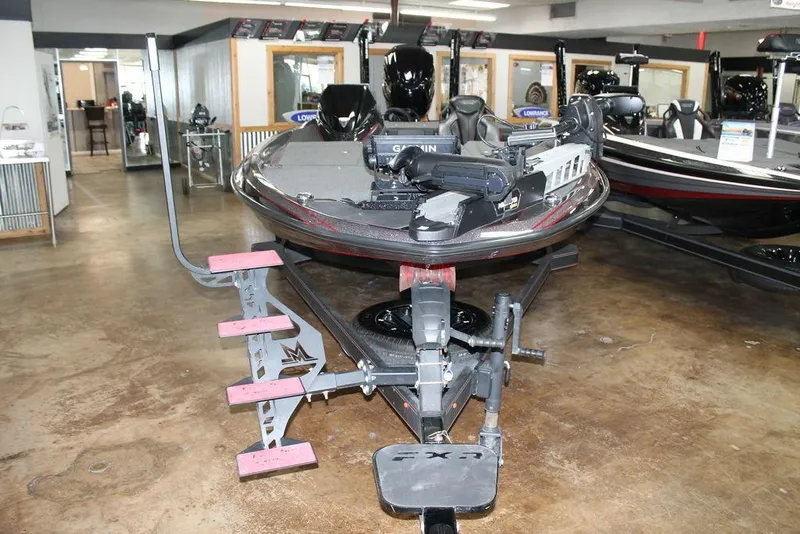 Slide: The Image of 2025 Skeeter FXR21L bass boat displayed in showroom with advanced fishing equipment. - 6