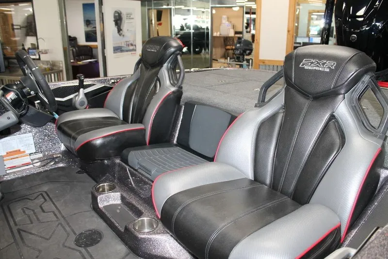 Slide: The Image of 2025 Skeeter FXR21L boat interior with sleek black and gray seats, modern design. - 8