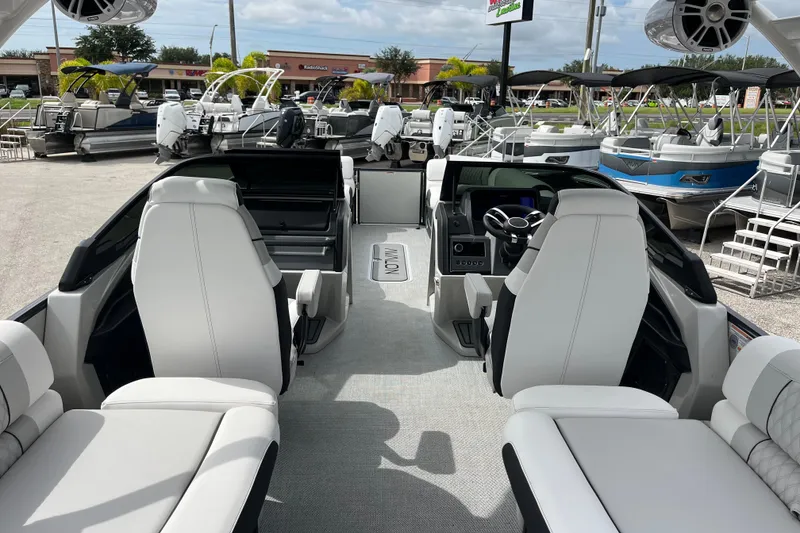 Slide: The Image of Interior of 2026 Avalon 2785 Excalibur LTD boat with luxurious seating and modern controls. - 12