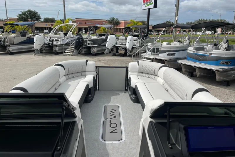 Slide: The Image of 2026 Avalon 2785 Excalibur LTD boat with luxurious seating, displayed at a dealership. - 15