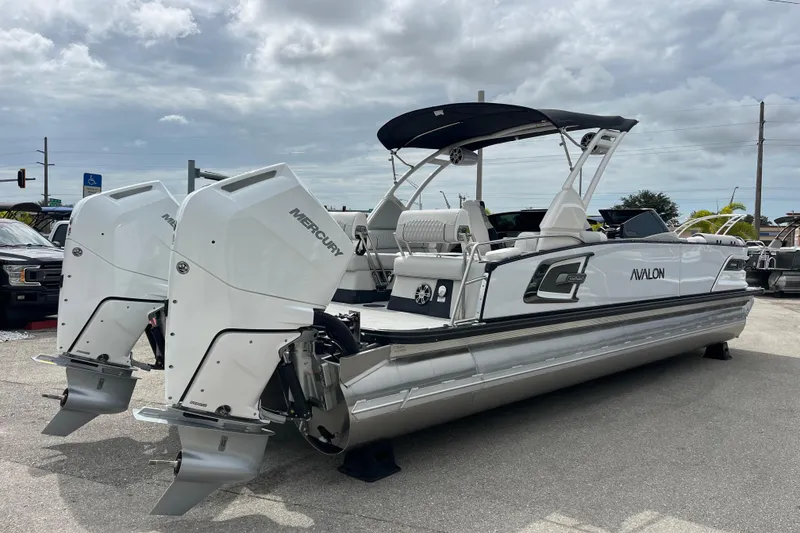 Slide: The Image of 2026 Avalon 2785 Excalibur LTD boat with twin Mercury 400hp V-10 engines, parked outdoors. - 5