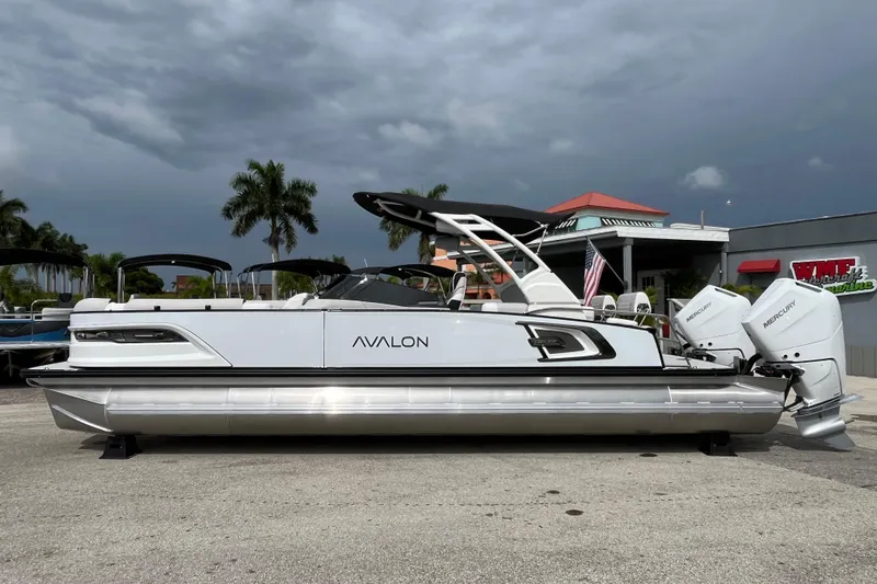 Slide: The Image of 2026 Avalon 2785 Excalibur LTD boat with twin Mercury 400hp engines, parked outdoors. - 8