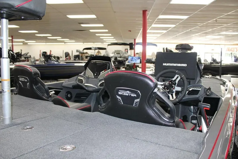 Slide: The Image of 2025 Skeeter FXR21 Apex boat interior with advanced steering and seating in showroom. - 8