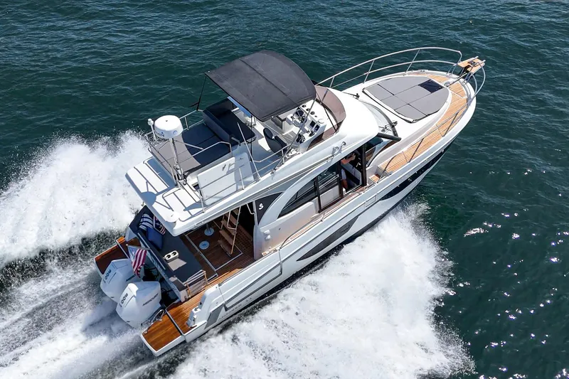 Slide: The Image of 2023 Beneteau Antares 11 Fly cruising on open water, aerial view. - 11