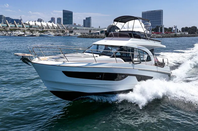 Slide: The Image of 2023 Beneteau Antares 11 Fly cruising in a vibrant marina setting. - 2
