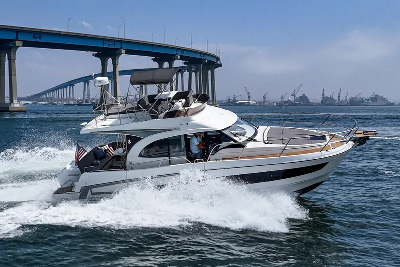 Slide: The Image of 2023 Beneteau Antares 11 Fly cruising under a bridge on a sunny day. - 20