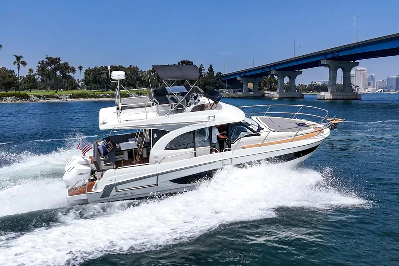 Slide: The Image of 2023 Beneteau Antares 11 Fly cruising under a bridge on a sunny day. - 21