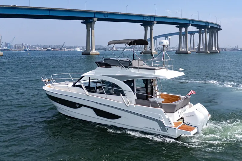 Slide: The Image of 2023 Beneteau Antares 11 Fly cruising under a bridge on a sunny day. - 25