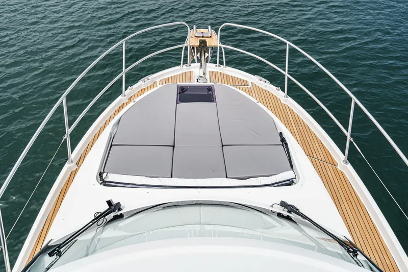 Slide: The Image of 2023 Beneteau Antares 11 Fly yacht deck with sunbed, surrounded by water. - 29