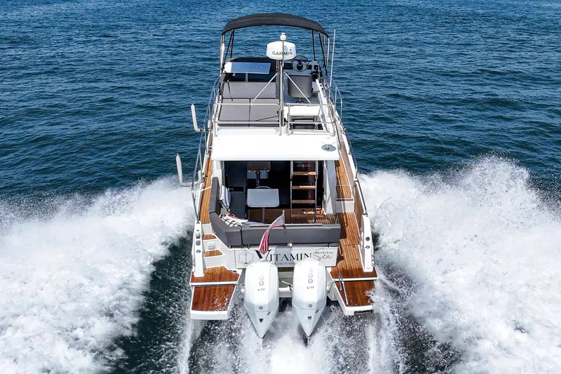 Slide: The Image of 2023 Beneteau Antares 11 Fly cruising on open water, rear view, powerful twin engines. - 30