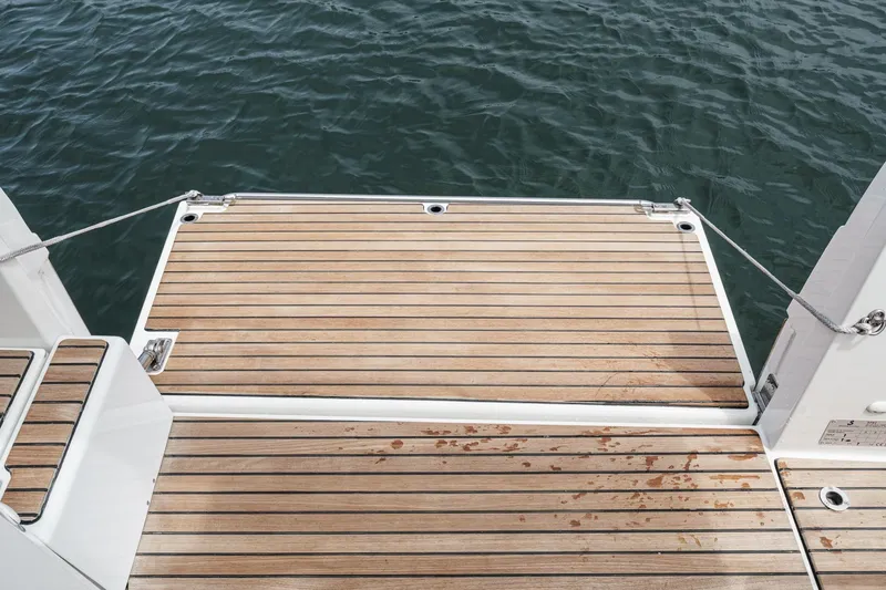 Slide: The Image of 2023 Beneteau Antares 11 Fly swim platform with teak decking, overlooking calm water. - 34