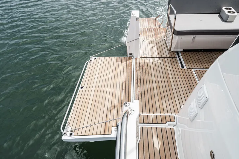 Slide: The Image of 2023 Beneteau Antares 11 Fly boat deck with wooden finish and water view. - 35