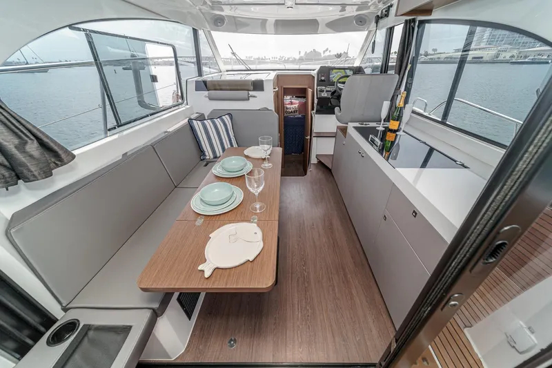 Slide: The Image of Interior of 2023 Beneteau Antares 11 Fly yacht with elegant dining setup and modern design. - 39