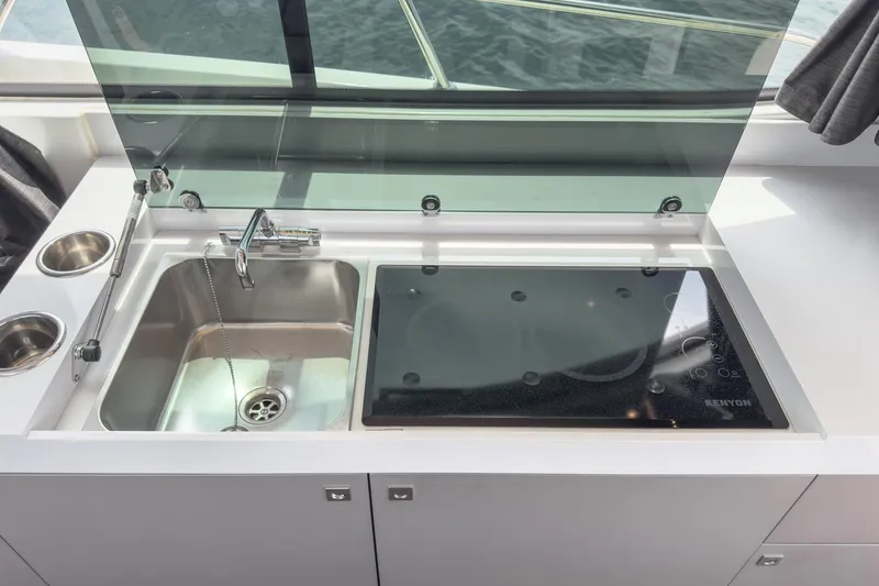 Slide: The Image of 2023 Beneteau Antares 11 Fly kitchen with sink and glass cooktop. - 42