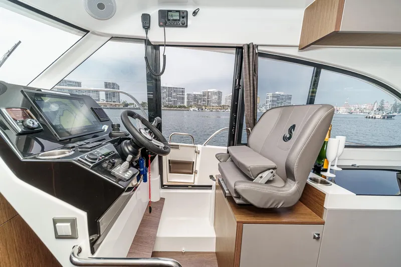 Slide: The Image of Interior cockpit of 2023 Beneteau Antares 11 Fly, featuring modern navigation equipment and luxurious seating. - 43