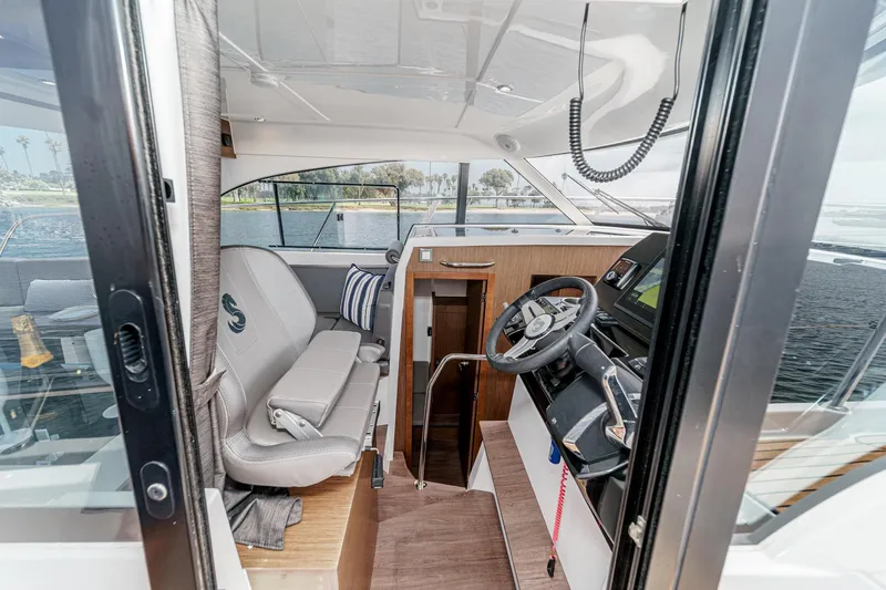 Slide: The Image of Interior view of 2023 Beneteau Antares 11 Fly, featuring helm and seating area. - 46