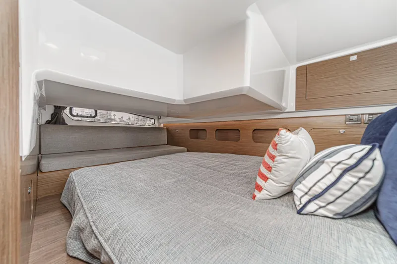 Slide: The Image of 2023 Beneteau Antares 11 Fly cabin interior with cozy bedding and modern design. - 50