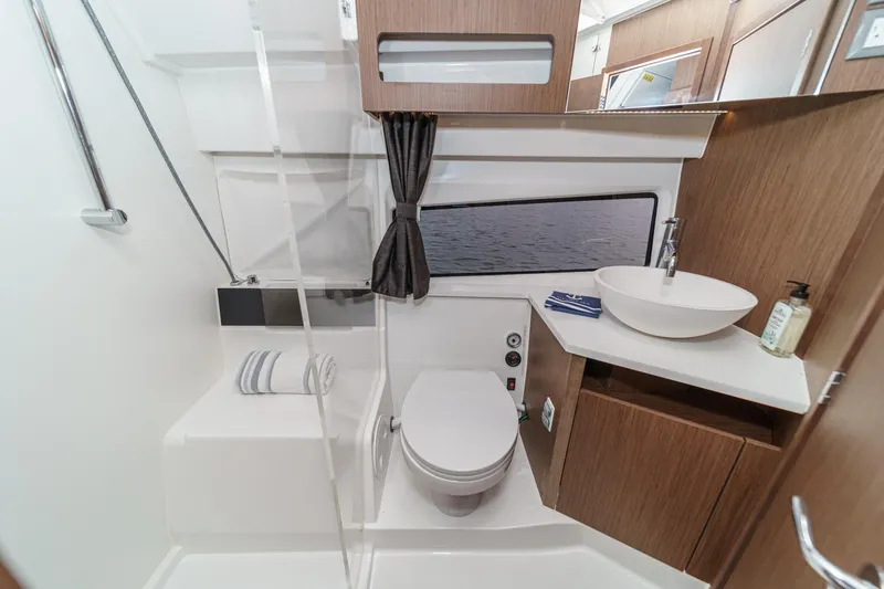 Slide: The Image of Modern bathroom in 2023 Beneteau Antares 11 Fly yacht with sleek fixtures and wood accents. - 52