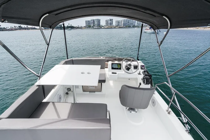 Slide: The Image of 2023 Beneteau Antares 11 Flybridge with helm, seating, and ocean view. - 56