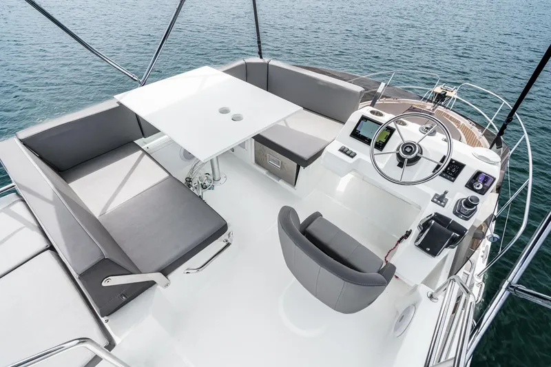 Slide: The Image of Flybridge of 2023 Beneteau Antares 11 Fly with seating and helm, overlooking the water. - 57