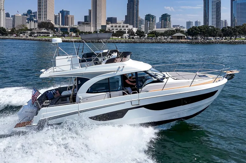 Slide: The Image of 2023 Beneteau Antares 11 Fly cruising near city skyline on a sunny day. - 6