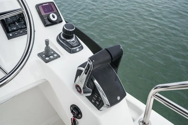 Slide: The Image of Control panel of 2023 Beneteau Antares 11 Fly boat with throttle and joystick. - 61