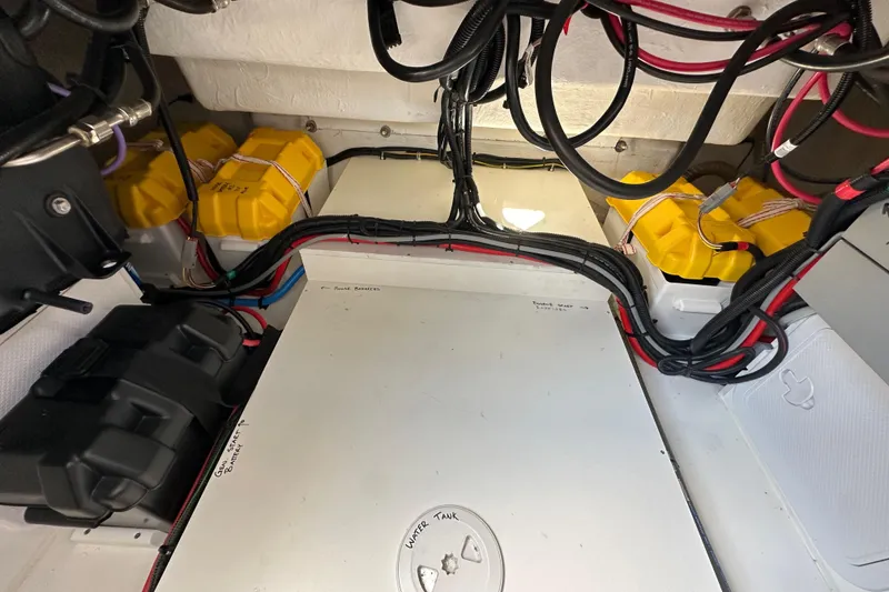 Slide: The Image of Engine compartment of 2023 Beneteau Antares 11 Fly with batteries and wiring. - 66