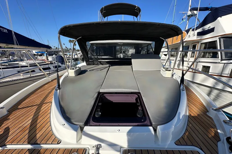 Slide: The Image of 2023 Beneteau Antares 11 Fly yacht with spacious deck and sunshade, docked at marina. - 71