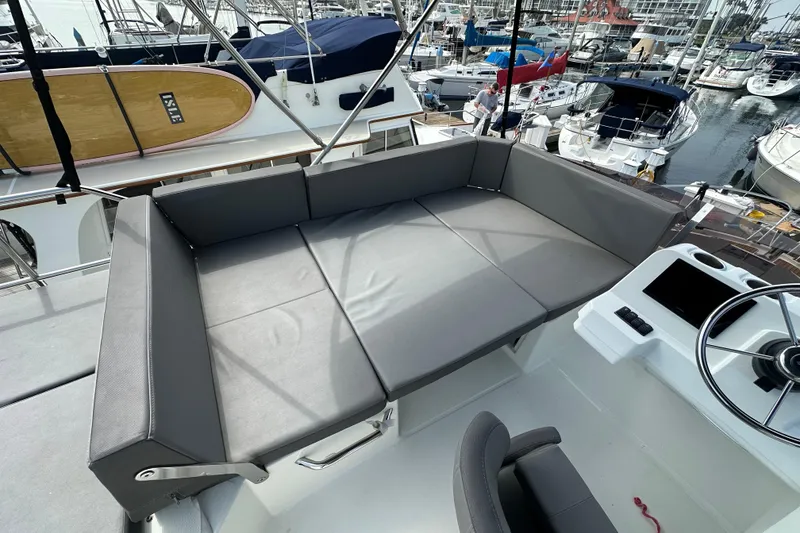 Slide: The Image of Flybridge seating area on 2023 Beneteau Antares 11 Fly, overlooking marina. - 75