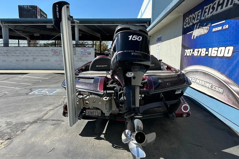 Slide: The Image of 2010 Ranger 178 VS boat with 150 HP motor parked outside a marine shop. - 10