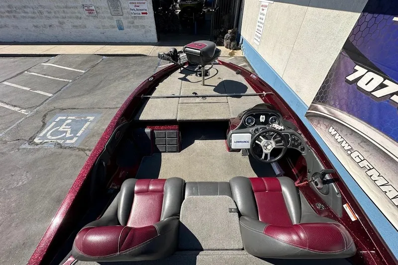 Slide: The Image of 2010 Ranger 178 VS boat interior with red and gray seating, steering wheel, and Lowrance device. - 12