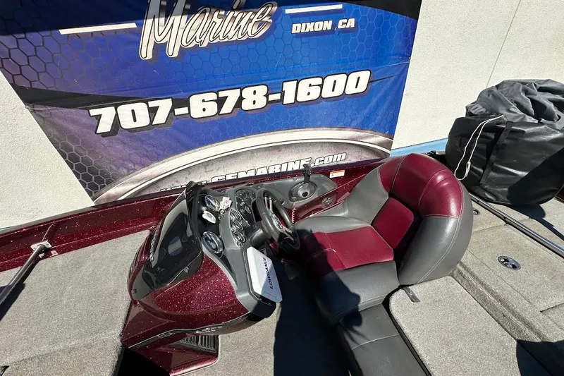 Slide: The Image of 2010 Ranger 178 VS boat interior with maroon and gray seating, dashboard, and control panel. - 14