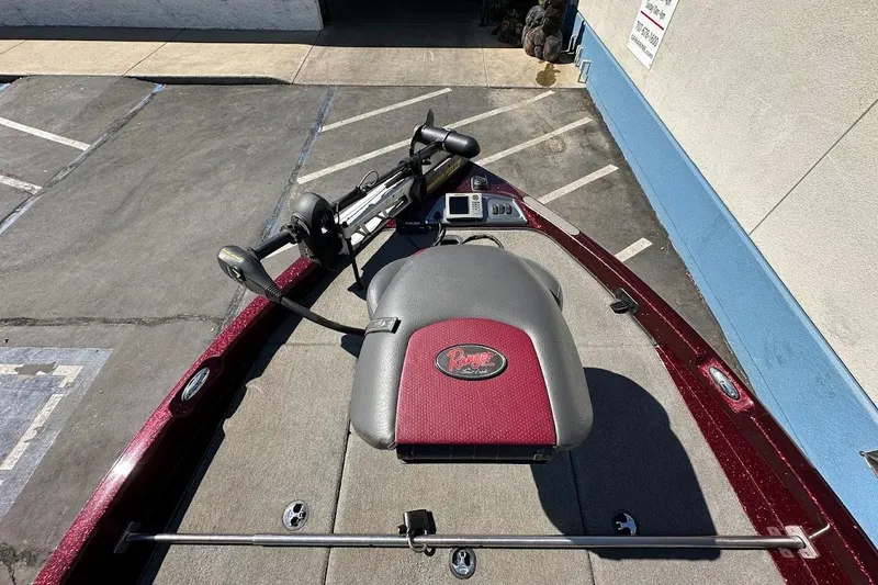 Slide: The Image of 2010 Ranger 178 VS boat deck with trolling motor and seat, parked on concrete. - 20
