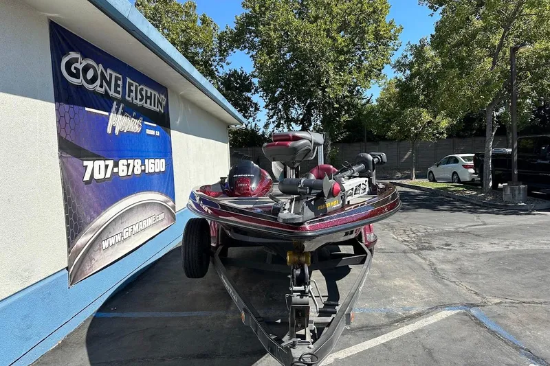 Slide: The Image of 2010 Ranger 178 VS boat parked near "Gone Fishin'" sign, outdoor setting. - 3
