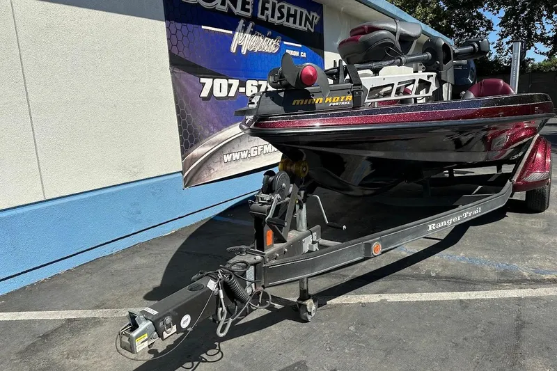 Slide: The Image of 2010 Ranger 178 VS boat on trailer, parked outside a building with a promotional banner. - 4