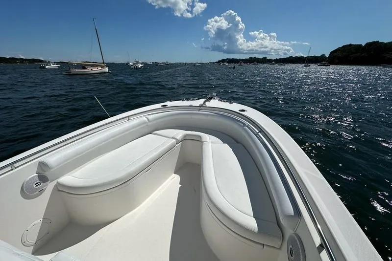 Slide: The Image of 2007 Edgewater 245CC boat on water, featuring spacious seating and scenic ocean view. - 10