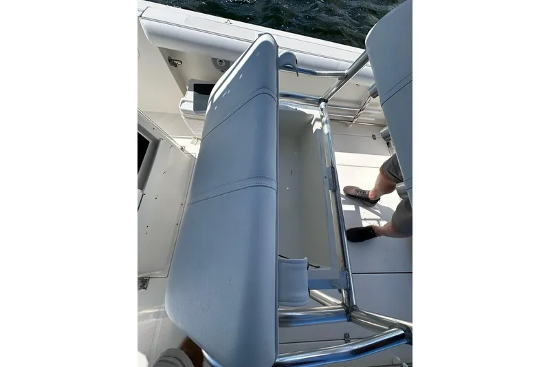 Slide: The Image of 2007 Edgewater 245CC boat interior with seating and storage area. - 11