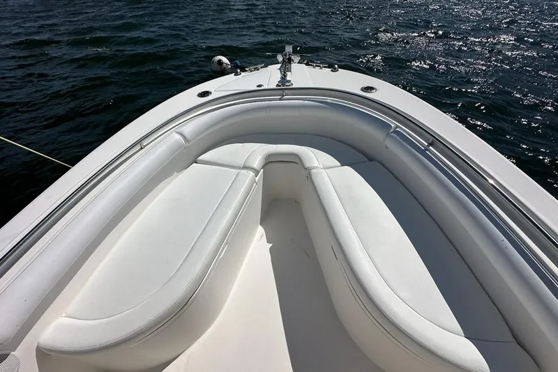 Slide: The Image of Bow seating area of 2007 Edgewater 245CC boat on water. - 12