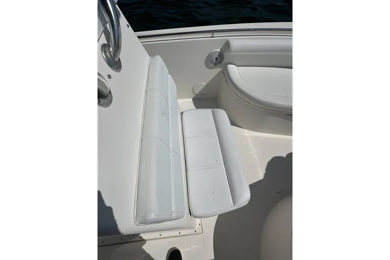 Slide: The Image of 2007 Edgewater 245CC boat interior with white cushioned seating. - 14