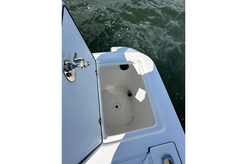 Slide: The Image of Open storage compartment on 2007 Edgewater 245CC boat, near water surface. - 18