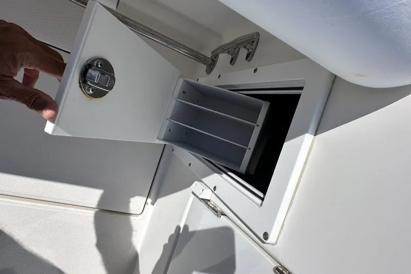 Slide: The Image of Open storage compartment on a 2007 Edgewater 245CC boat, showing interior dividers. - 21