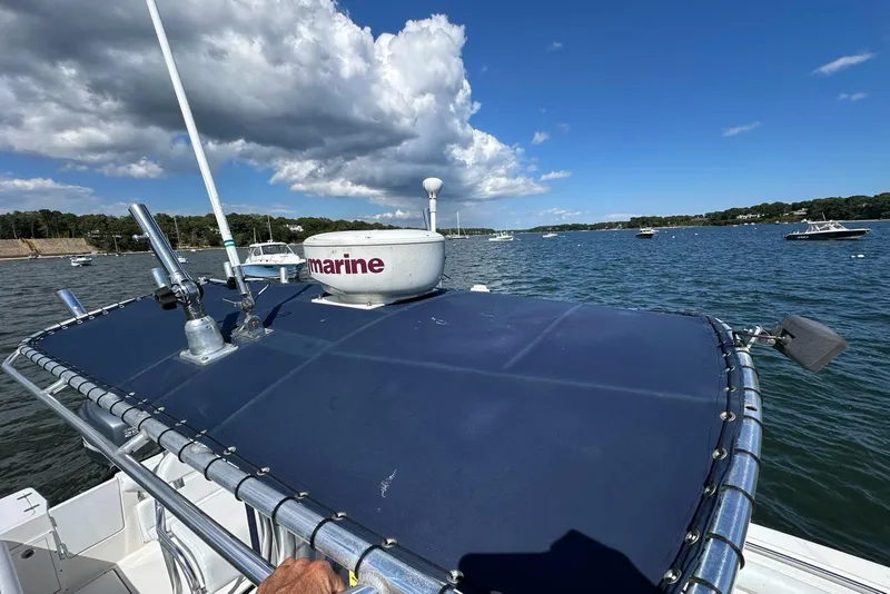 Slide: The Image of 2007 Edgewater 245CC boat on water, clear sky, radar equipment visible. - 26