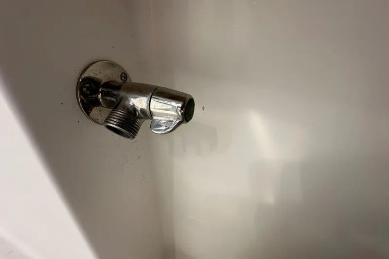 Slide: The Image of Chrome boat fitting on Edgewater 245CC, 2007 model, against a white surface. - 27