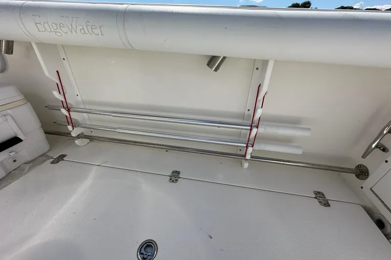 Slide: The Image of 2007 Edgewater 245CC boat interior with rod holders and storage. - 28