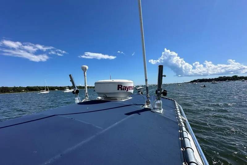 Slide: The Image of 2007 Edgewater 245CC boat on water under clear blue sky. - 31