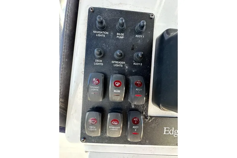 Slide: The Image of Control panel of a 2007 Edgewater 245CC boat with various switches. - 4