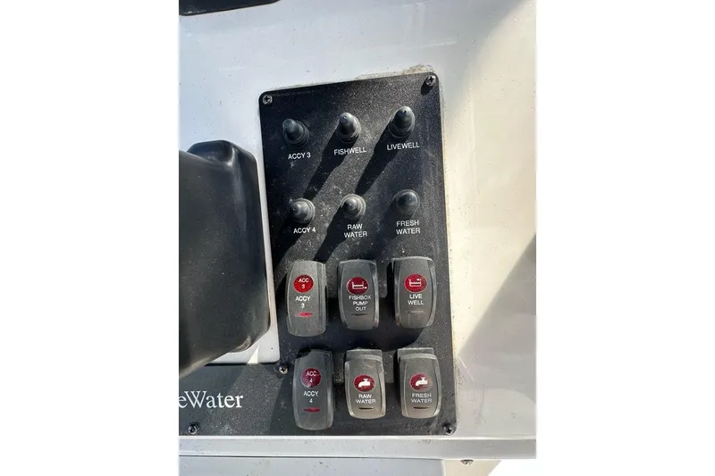 Slide: The Image of Control panel of a 2007 Edgewater 245CC boat with various switches. - 5