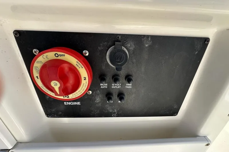 Slide: The Image of Control panel of a 2007 Edgewater 245CC boat with engine switch and 12V outlet. - 6